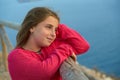 Blond girl looking sea from a lookout point Royalty Free Stock Photo