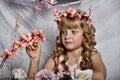 Blond girl in a pink dress with flowers Royalty Free Stock Photo