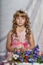 Blond girl in a pink dress with flowers Royalty Free Stock Photo