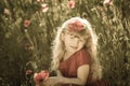 Blond girl in poppy field