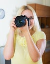 Blond girl with professional photocamera Royalty Free Stock Photo