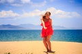 blond girl in red dances on sand Royalty Free Stock Photo