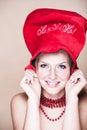 Blond girl in red necklace and hat Royalty Free Stock Photo