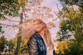 Blond girl is shking her head as her long hairs fly in the air Royalty Free Stock Photo