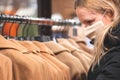 Blond girl in a shop with mask