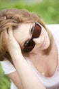 Blond girl in sunglasses at the summer park. Royalty Free Stock Photo