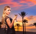 Blond girl sunset Arenal beach drinking vermout Royalty Free Stock Photo