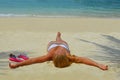 Blond girl suntanning on the beach Royalty Free Stock Photo