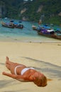 Blond girl suntanning on the beach Royalty Free Stock Photo