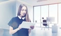 Blond girl with tablet posing in her boss's office