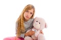 Blond girl with teddy bear thermometer and flu