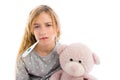 Blond girl with thermometer and flu cold in pyjama