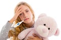 Blond girl with thermometer and flu cold in pyjama