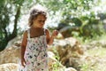 A blond girl of three years thoughtful near the Acheron River with its pristine nature in Epirus