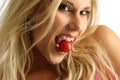 Blond girl with tomato Royalty Free Stock Photo