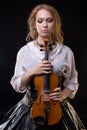 Blond girl with the violin and looking down Royalty Free Stock Photo