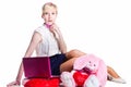 Blond girl working with pink laptop