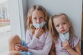 Blond girls do not want to get sick do not want to wear masks against coronovirus. children want to go outside covid
