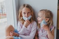 Blond girls do not want to get sick do not want to wear masks against coronovirus. children want to go outside covid