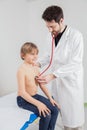 A blond hair boy with the children doctor examination