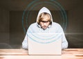 Blond hair hacker using a laptop in a room Royalty Free Stock Photo