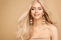 Blond Hair Model with Golden Earrings Jewelry and Natural Make up. Smiling Beauty Model Face Portrait with waving Hairstyle