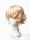 Blond hair wig on a woman mannequin on white background.