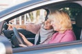 Blond hair woman driving - two women in the car looking for the same way Royalty Free Stock Photo