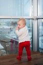 Blond baby girl years old in the interior in the evening