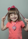 A blond-haired child, with a smile and squeezed eyes. Wearing pilot's glasses and an emblem. Puppy Patrol Royalty Free Stock Photo