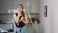 blond-haired woman with a hammer in her hand thinking about the renovation in the kitchen, tools in the background Royalty Free Stock Photo