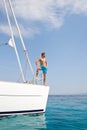 Blond handsome young man posing on sailing boat. Royalty Free Stock Photo