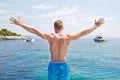 Blond handsome young man standing on a sailing boat - ready to j Royalty Free Stock Photo