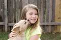 Blond kid girl with chihuahua pet dog playing Royalty Free Stock Photo