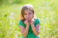 Blond kid girl excited gesture expression in green outdoor