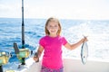 Blond kid girl fishing tuna little tunny happy with catch