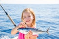 Blond kid girl fishing tuna little tunny happy with catch Royalty Free Stock Photo
