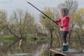 Blond kid girl fishing tuna little tunny happy with trolling catch on boat deck Royalty Free Stock Photo