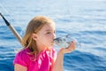 Blond kid girl fishing tuna little tunny kissing for release Royalty Free Stock Photo