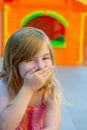 Blond kid girl funny gesture hand in mouth