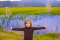 Blond kid girl outdoor holding spike in wetlands lake Royalty Free Stock Photo