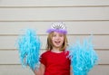 Blond kid girl playing like cheerleading pom poms and crown Royalty Free Stock Photo