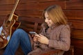 Blond kid girl playing smartphone Royalty Free Stock Photo