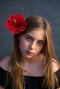 Blond kid girl portrait with red flower in hair Royalty Free Stock Photo