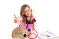 Blond kid girl pretending be doctor with hedgehog Royalty Free Stock Photo
