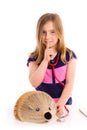 Blond kid girl pretending be doctor with hedgehog