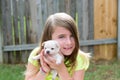 Blond kid girl with puppy pet chihuahua playing Royalty Free Stock Photo