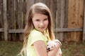 Blond kid girl with puppy pet chihuahua playing Royalty Free Stock Photo