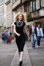 Blond lady walking along street