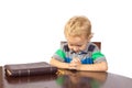 Blond little boy praying to God after reading the bible Royalty Free Stock Photo